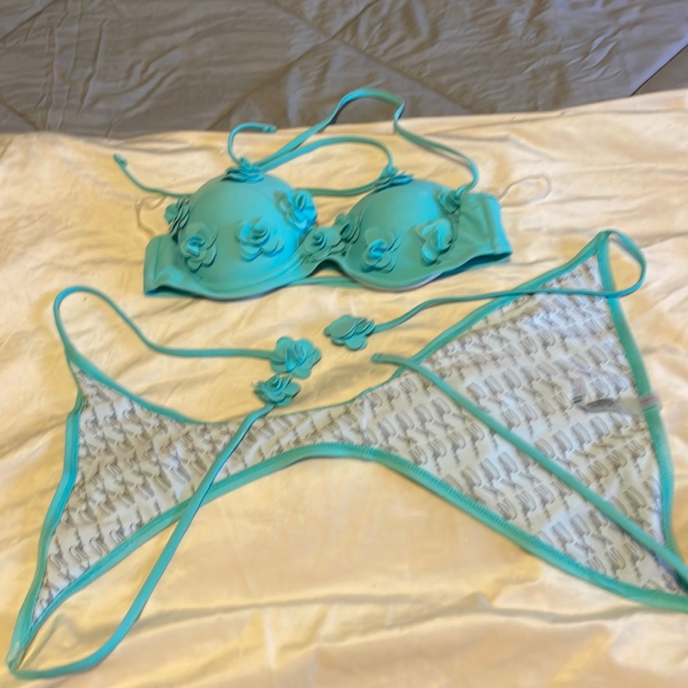 Two piece swimsuit turquoise top is a medium bottoms are a small worn once